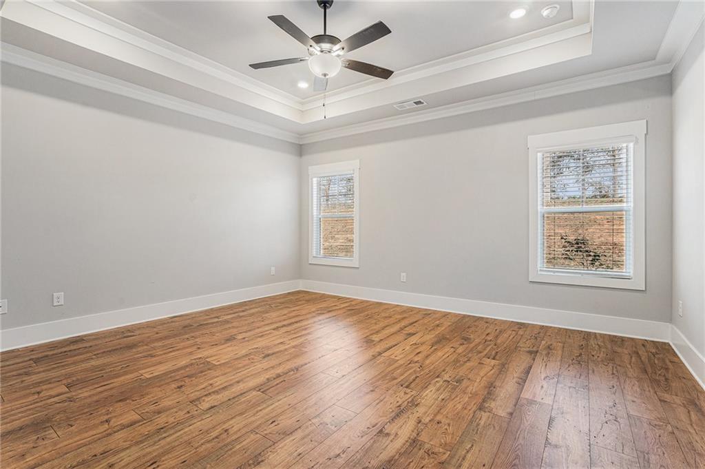 1119 Heights View Way Monroe, GA 30655 - Photo 21 of 30 wooden floor in an empty room with a window