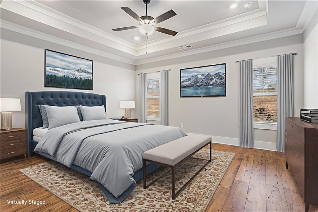 1119 Heights View Way Monroe, GA 30655 - Photo 22 of 30 a bedroom with a large bed and a chandelier