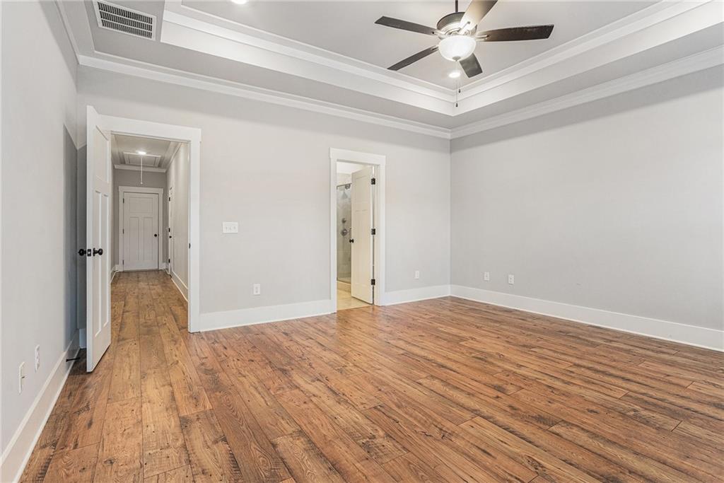 1119 Heights View Way Monroe, GA 30655 - Photo 23 of 30 a view of empty room with wooden floor and ceiling fan