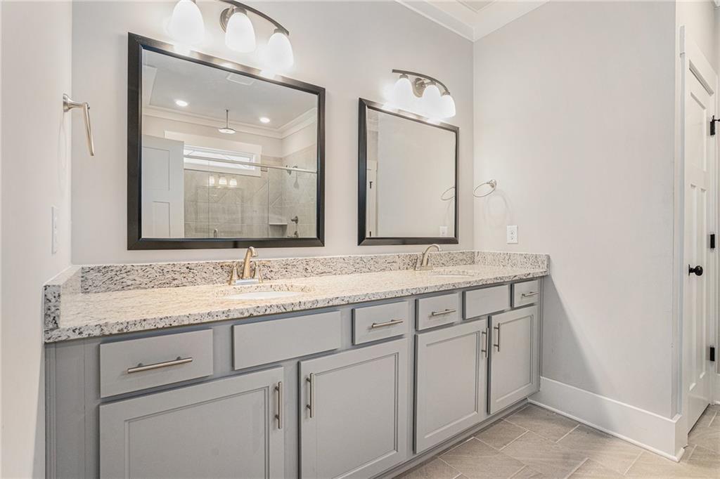 1119 Heights View Way Monroe, GA 30655 - Photo 25 of 30 a bathroom with a granite countertop sink and a mirror