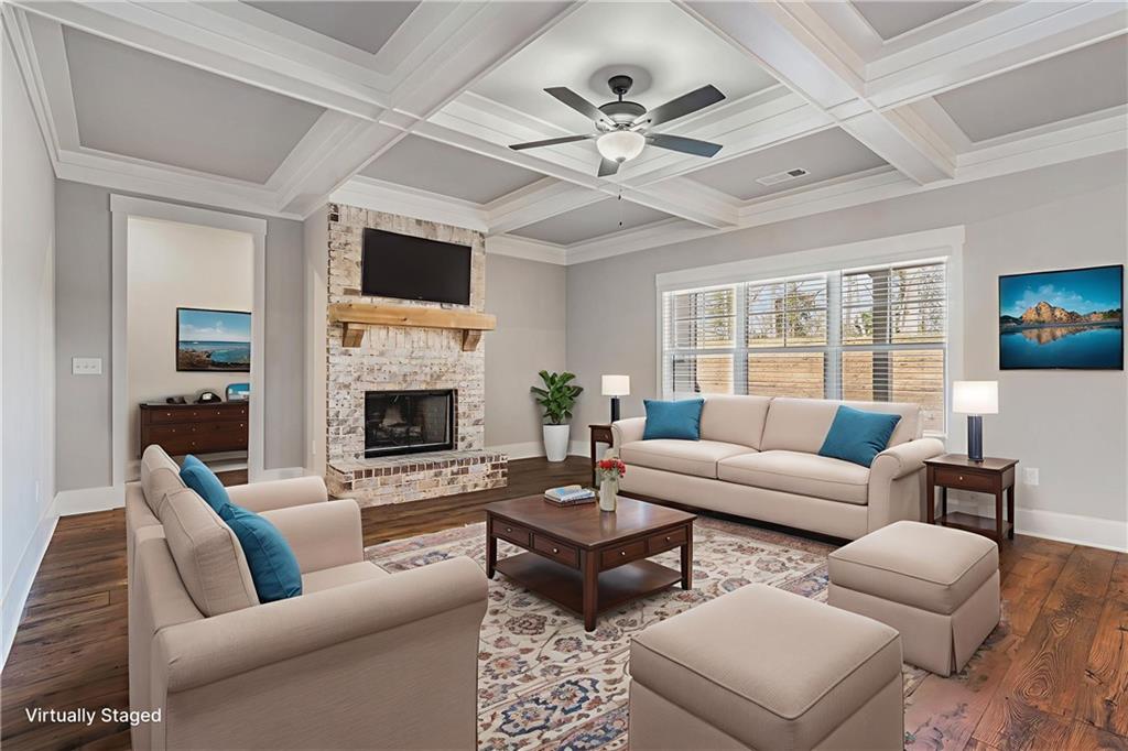 1119 Heights View Way Monroe, GA 30655 - Photo 3 of 30 a living room with furniture a flat screen tv and a fireplace