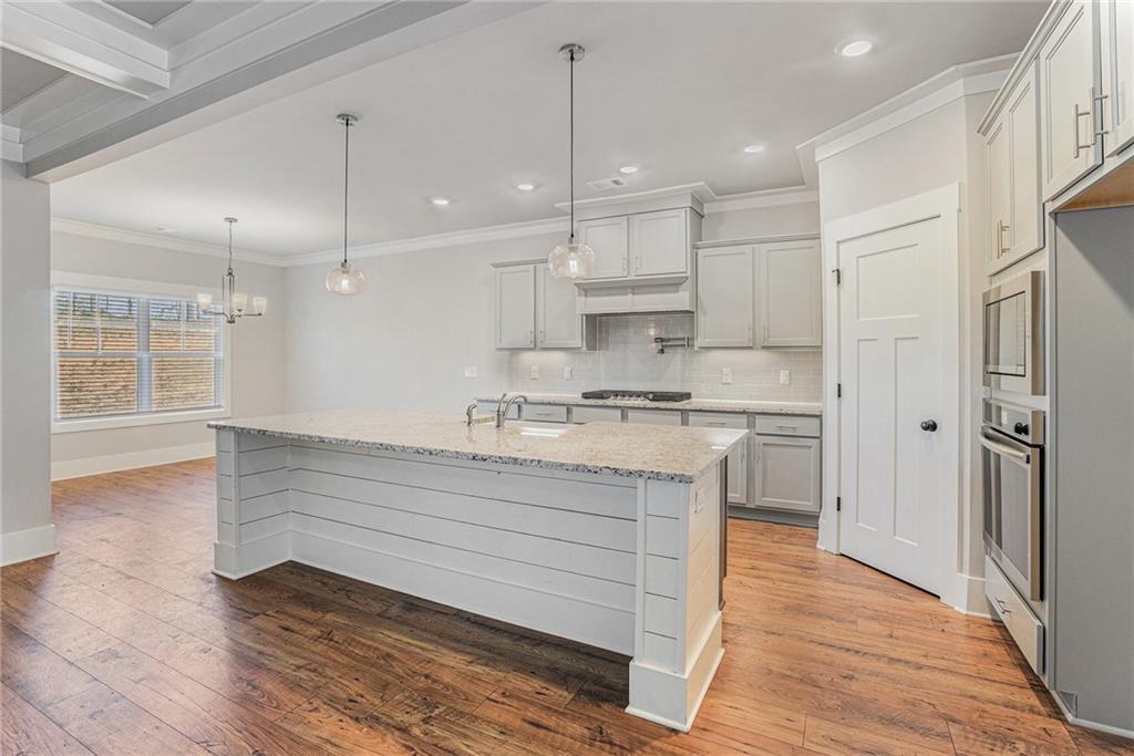 1119 Heights View Way Monroe, GA 30655 - Photo 4 of 30 a view of kitchen with granite countertop appliances cabinets and a wooden floor