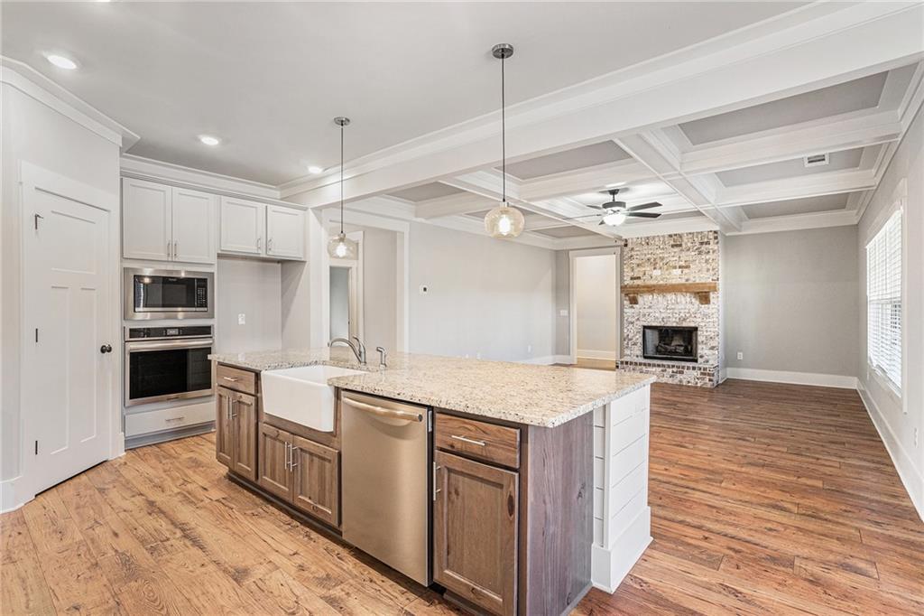 1119 Heights View Way Monroe, GA 30655 - Photo 5 of 30 a kitchen with stainless steel appliances granite countertop a sink a stove and a refrigerator