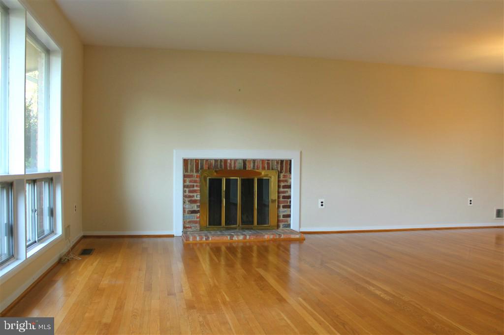 1049 Balls Hill Road McLean, VA 22101 - Photo 3 of 6 an empty room with wooden floor and windows