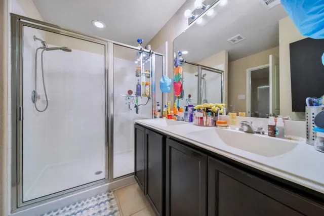 a bathroom with a double vanity sink mirror and double