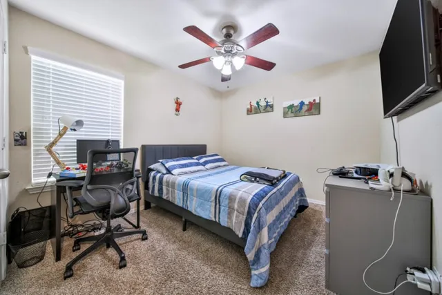 a bedroom with a bed and a desk