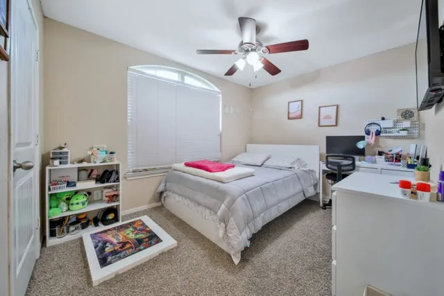 a bedroom with bed and a chandelier