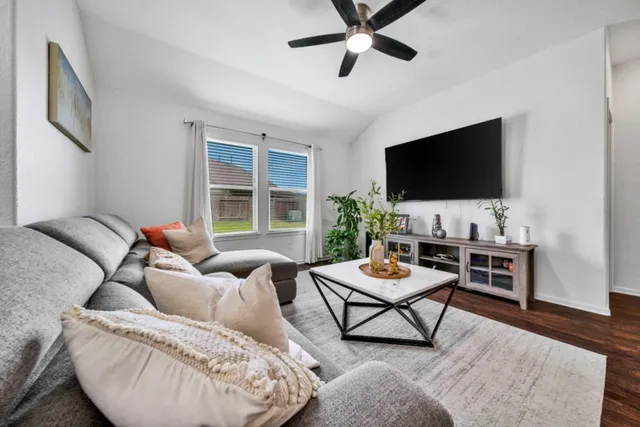 a living room with furniture and a flat screen tv