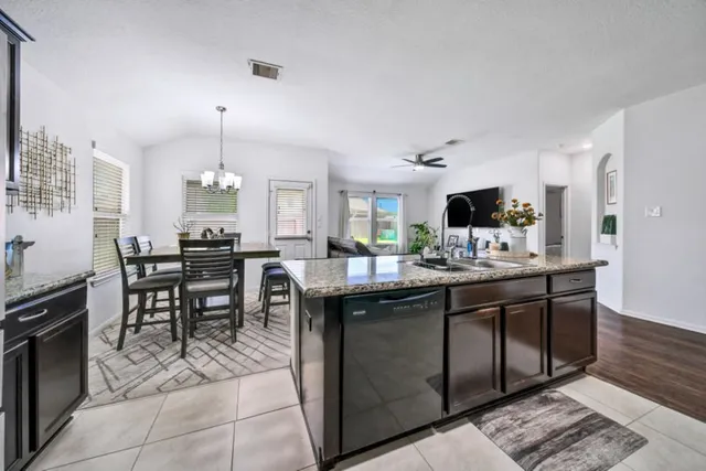 a kitchen with granite countertop a sink and appliances