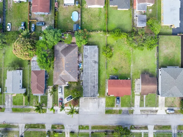 an aerial view of multiple houses with yard