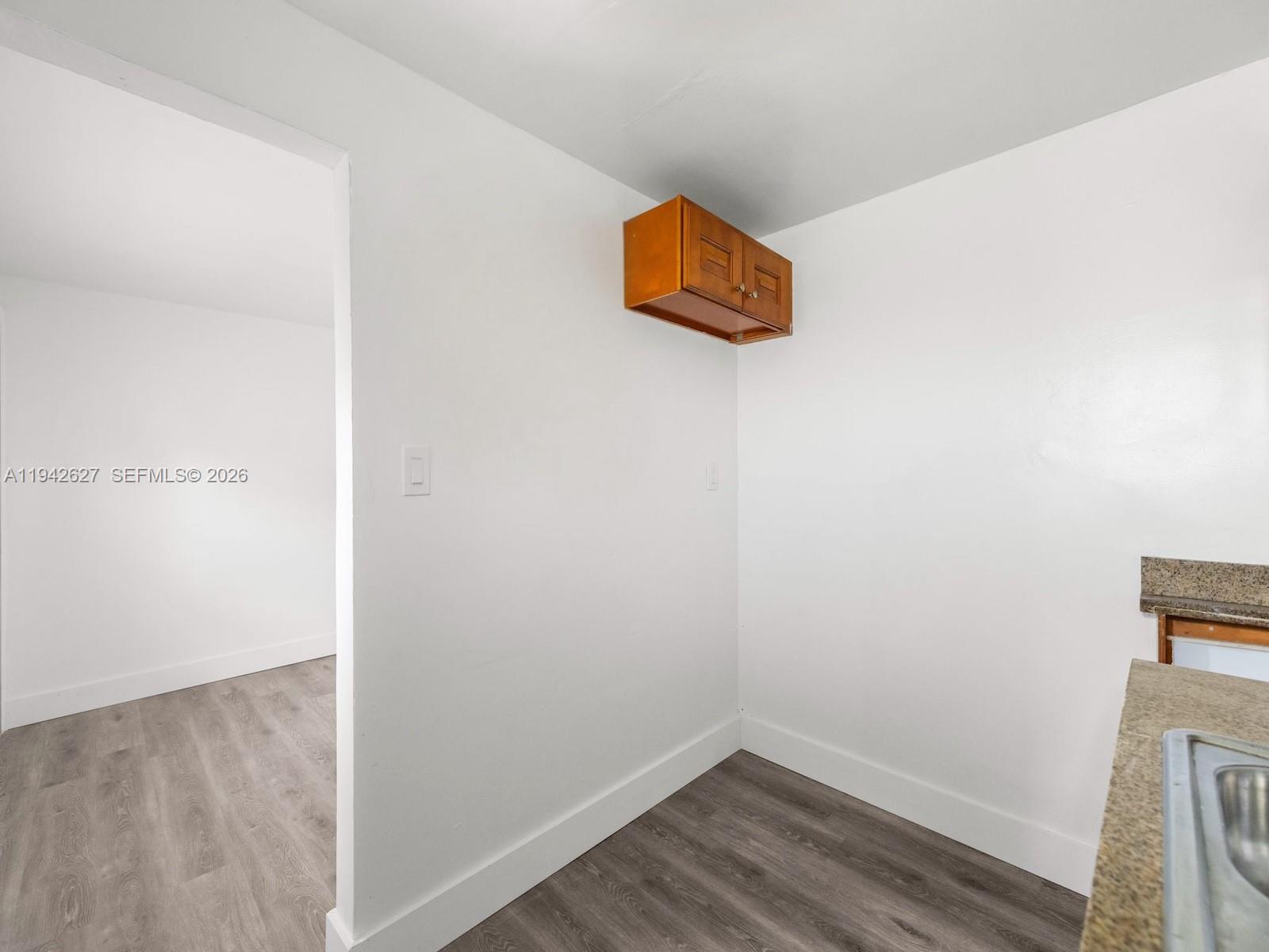 4017 Southwest 24th Street West Park, FL 33023 - Photo 7 of 19 a room with a wooden floor and a window
