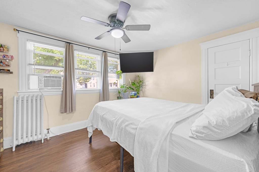 29 Sterling Street Springfield, MA 01107 - Photo 15 of 38 a bedroom with a large bed and a chandelier