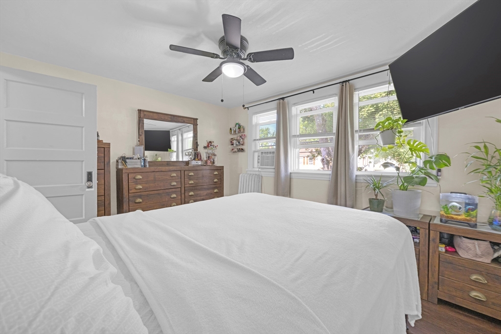 29 Sterling Street Springfield, MA 01107 - Photo 17 of 38 a bedroom with a large bed and a chandelier