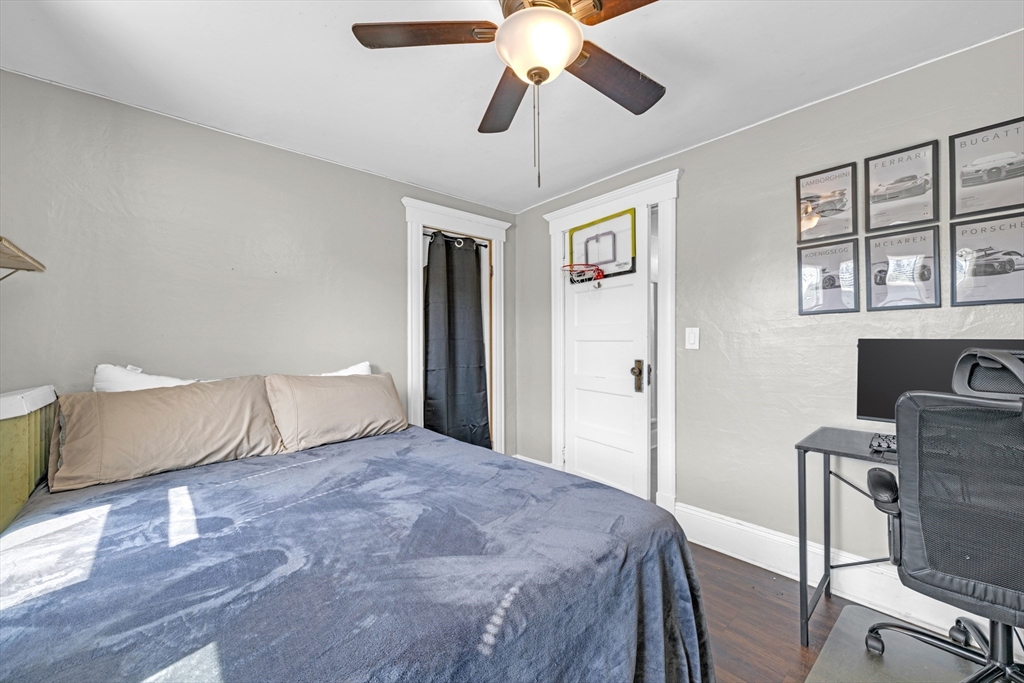 29 Sterling Street Springfield, MA 01107 - Photo 20 of 38 a bedroom with a bed and a chandelier