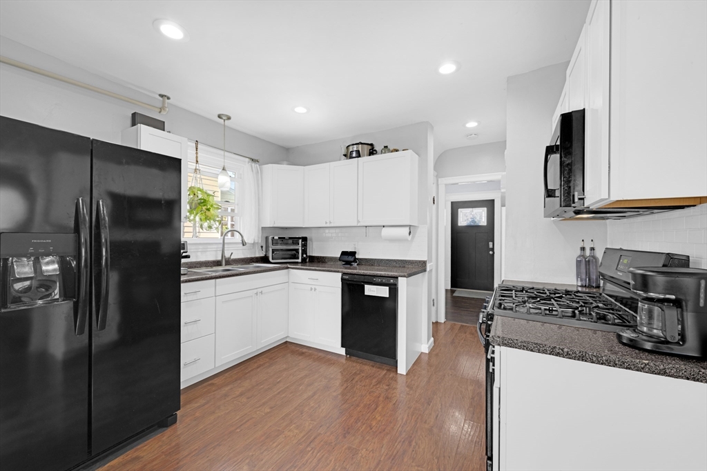 29 Sterling Street Springfield, MA 01107 - Photo 5 of 38 a kitchen with granite countertop a refrigerator stove top oven and sink