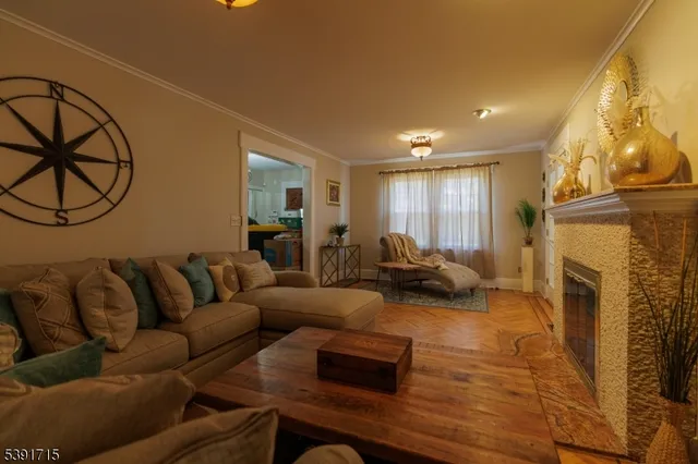 a living room with furniture a fireplace and a flat screen tv