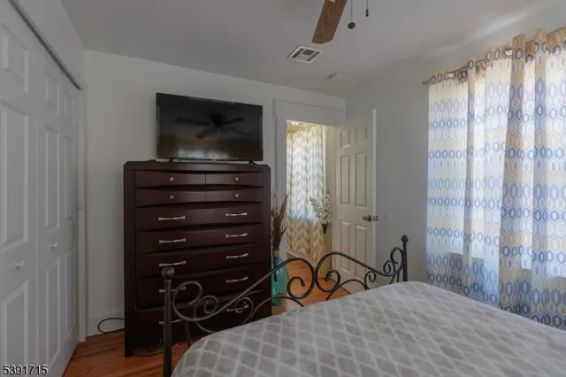 a bedroom with a bed and a television