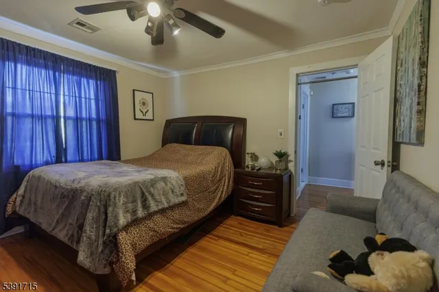 a spacious bedroom with a bed and a dresser