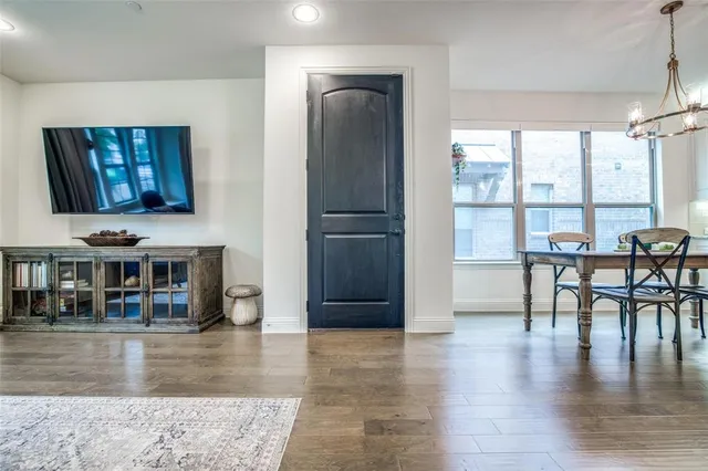 a view of a living room and dining room with wooden floor