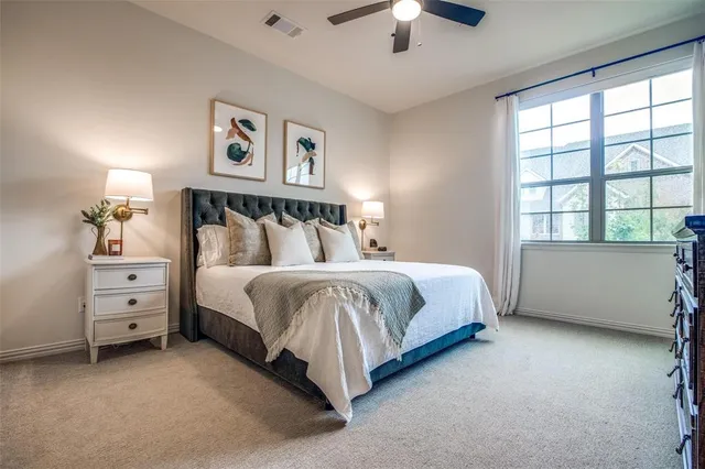 a spacious bedroom with a bed and a window