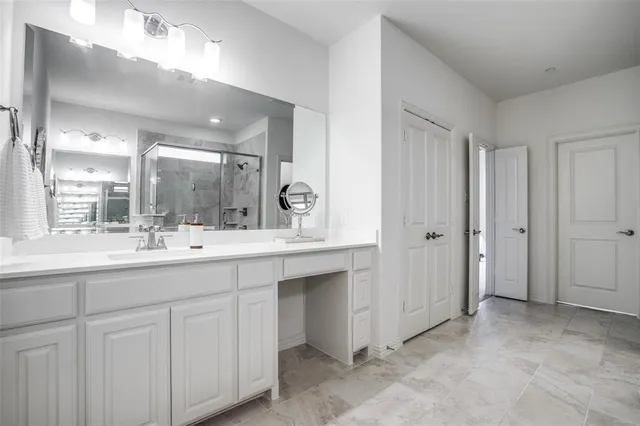 a bathroom with a double vanity sink and mirror
