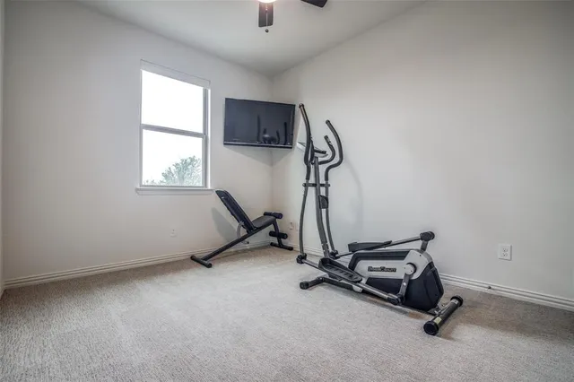 a room with gym equipment and windows