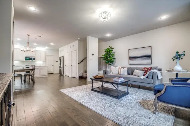 a living room with furniture and kitchen view