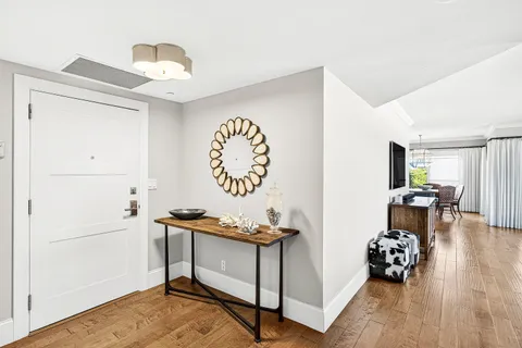 a large kitchen with kitchen island a sink a counter top space and living room view