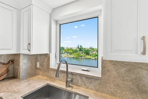 a kitchen with stainless steel appliances granite countertop a sink and refrigerator