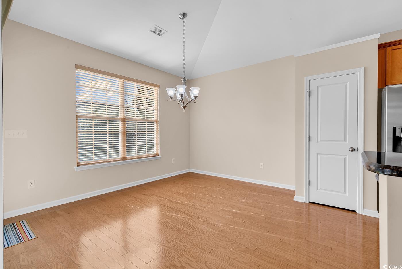 1612 Fairforest Court Conway, SC 29526 - Photo 10 of 40 Unfurnished room featuring light wood-type flooring and a chandelier