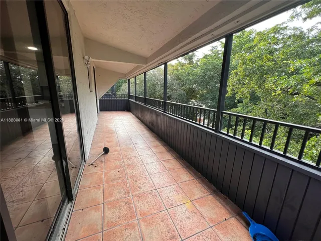 a view of balcony with wooden floor