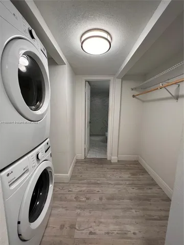 a view of a hallway with washer and dryer