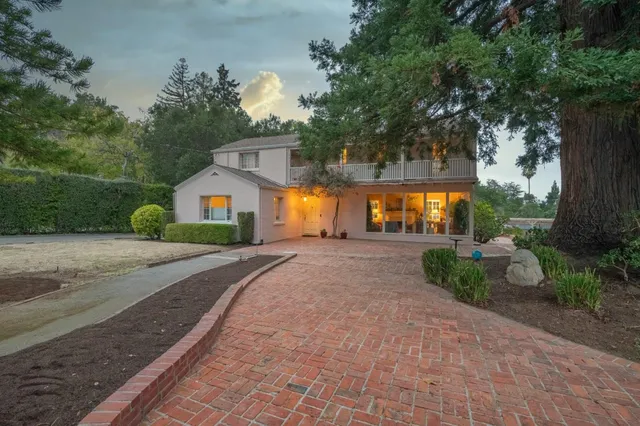 a view of house entrance and garden