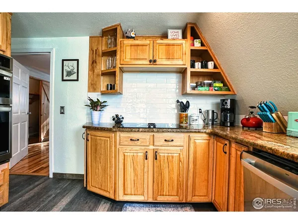 a kitchen with stainless steel appliances granite countertop a sink and cabinets