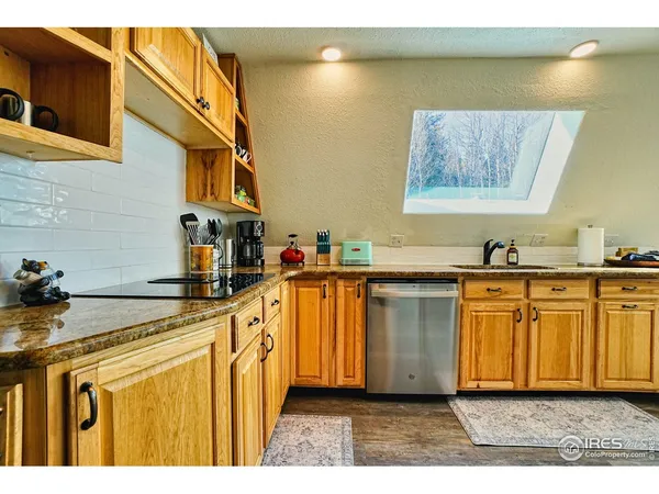 a kitchen with sink cabinets and wooden floor