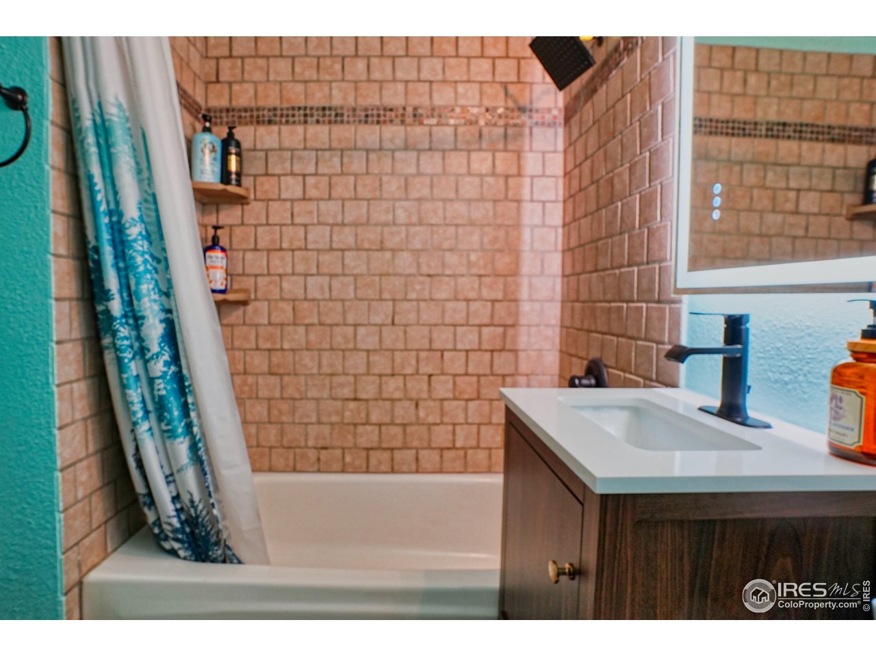 2170 Apex Valley Road Black Hawk, CO 80422 - Photo 18 of 50 a bathroom with a sink a mirror and shower
