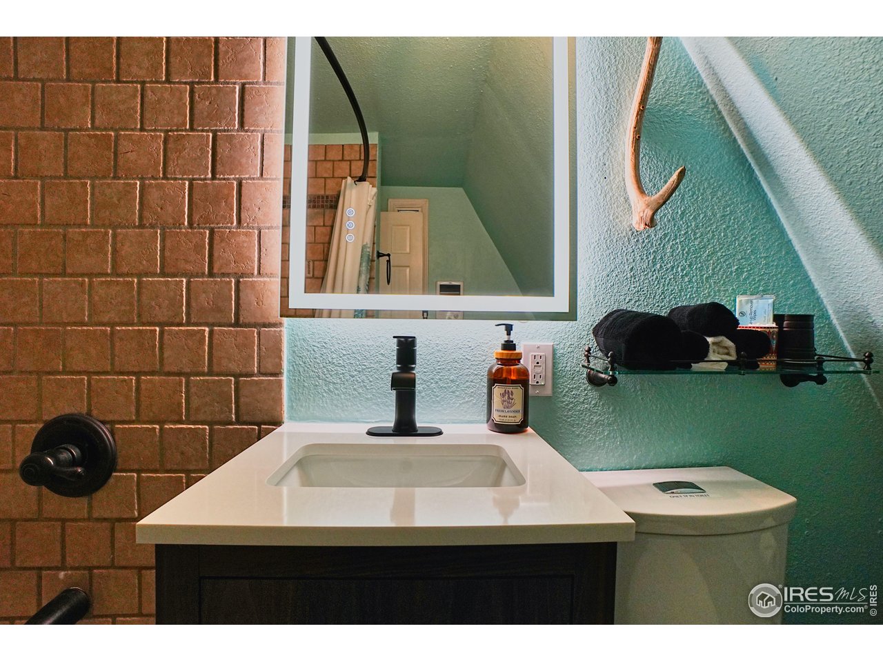 2170 Apex Valley Road Black Hawk, CO 80422 - Photo 20 of 50 a bathroom with a sink and a mirror