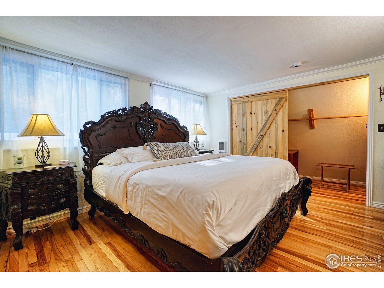 2170 Apex Valley Road Black Hawk, CO 80422 - Photo 21 of 50 a bedroom with a bed and a lamp on dresser