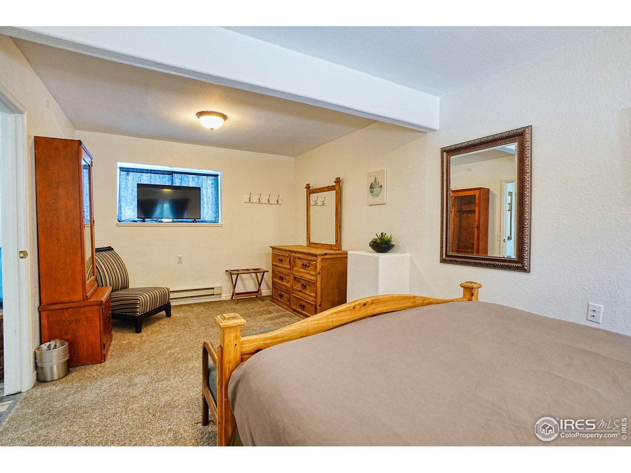 2170 Apex Valley Road Black Hawk, CO 80422 - Photo 29 of 50 a bedroom with a bed and wooden floor