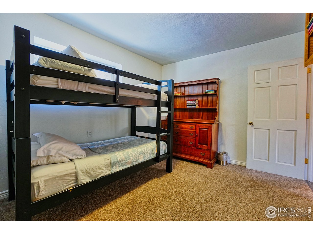 2170 Apex Valley Road Black Hawk, CO 80422 - Photo 40 of 50 a bedroom with a bed and cabinets