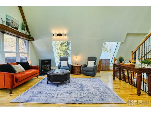 a living room with furniture a rug and a window