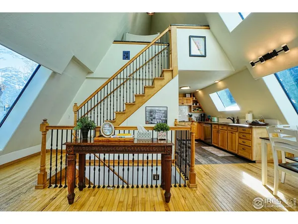 a view of entryway and hall with wooden floor