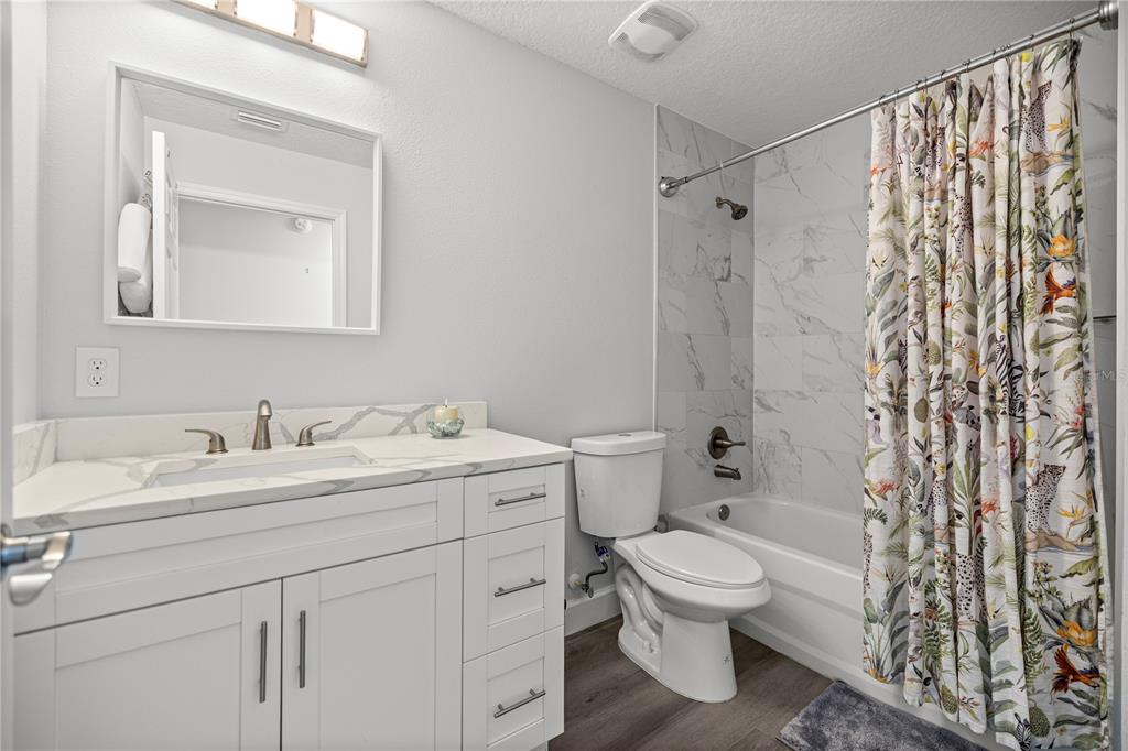 8607 Southwest 135th Street Road Ocala, FL 34473 - Photo 16 of 30 a bathroom with a toilet sink vanity granite and shower