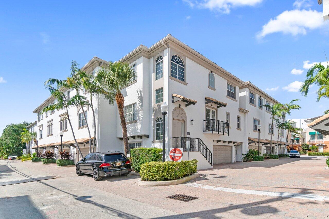 614 Renaissance Way Delray Beach, FL 33483 - Photo 1 of 25 a front view of a building with tree s
