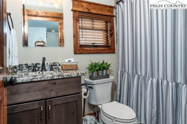 a view of a hallway with workspace and a window