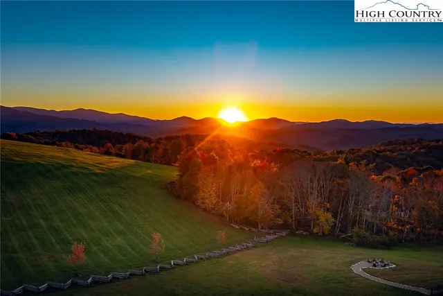 a living room with stainless steel appliances granite countertop a kitchen island a stove a table and chairs