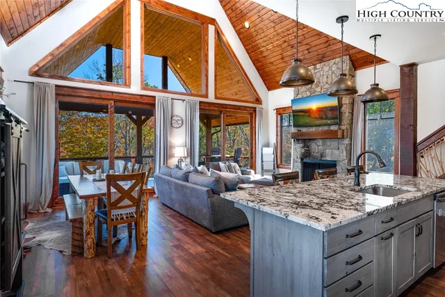 a living room with furniture a floor to ceiling window and a fireplace
