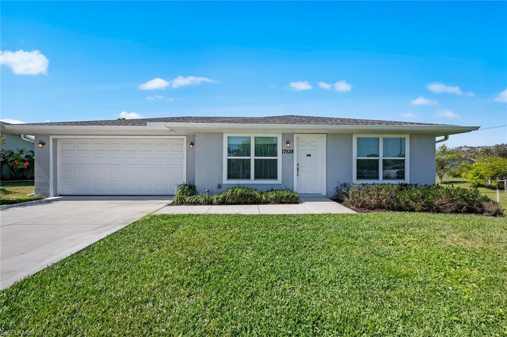 17528 Fuchsia Road Fort Myers, FL 33967 - Photo 1 of 42 a front view of a house with a yard and garage