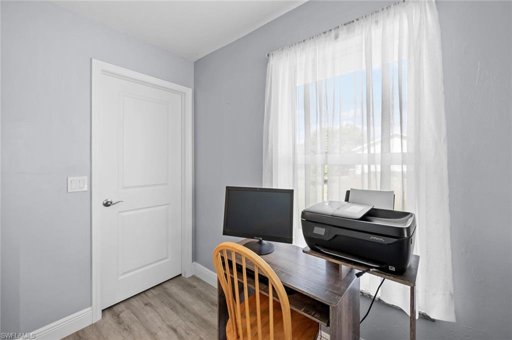 17528 Fuchsia Road Fort Myers, FL 33967 - Photo 27 of 42 a view of a workspace with furniture and a window