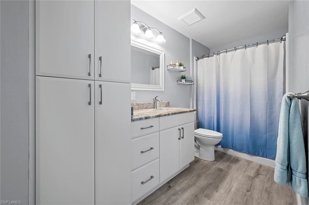 17528 Fuchsia Road Fort Myers, FL 33967 - Photo 29 of 42 a bathroom with a granite countertop sink toilet and shower